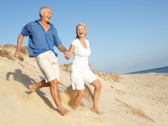 Seniors Laughing on Beach for Older Americans Month